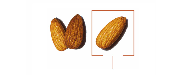 two almond in cluster and third one off to the right side with orange border around third almond