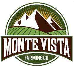 Monte Vista Farming Co badge logo with green field and brown mountains